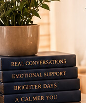 Warmly lit books and a cup of coffee